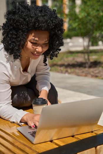 Woman Communicates By Laptop